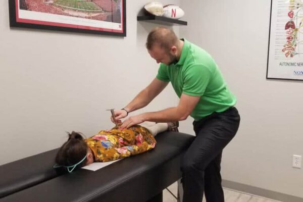 Dr.-Shane-Davidson-DC-doing-Pediatric-chiropractic-treatment-on-kid