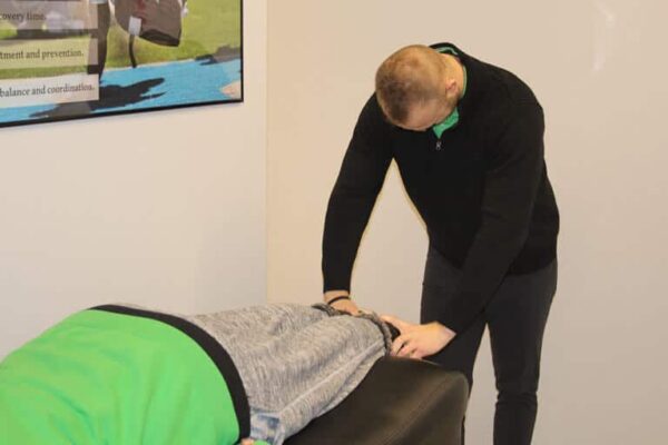 Dr.-Shane-Davidson-DC-doing-chiropractic-adjustment-on-Patient